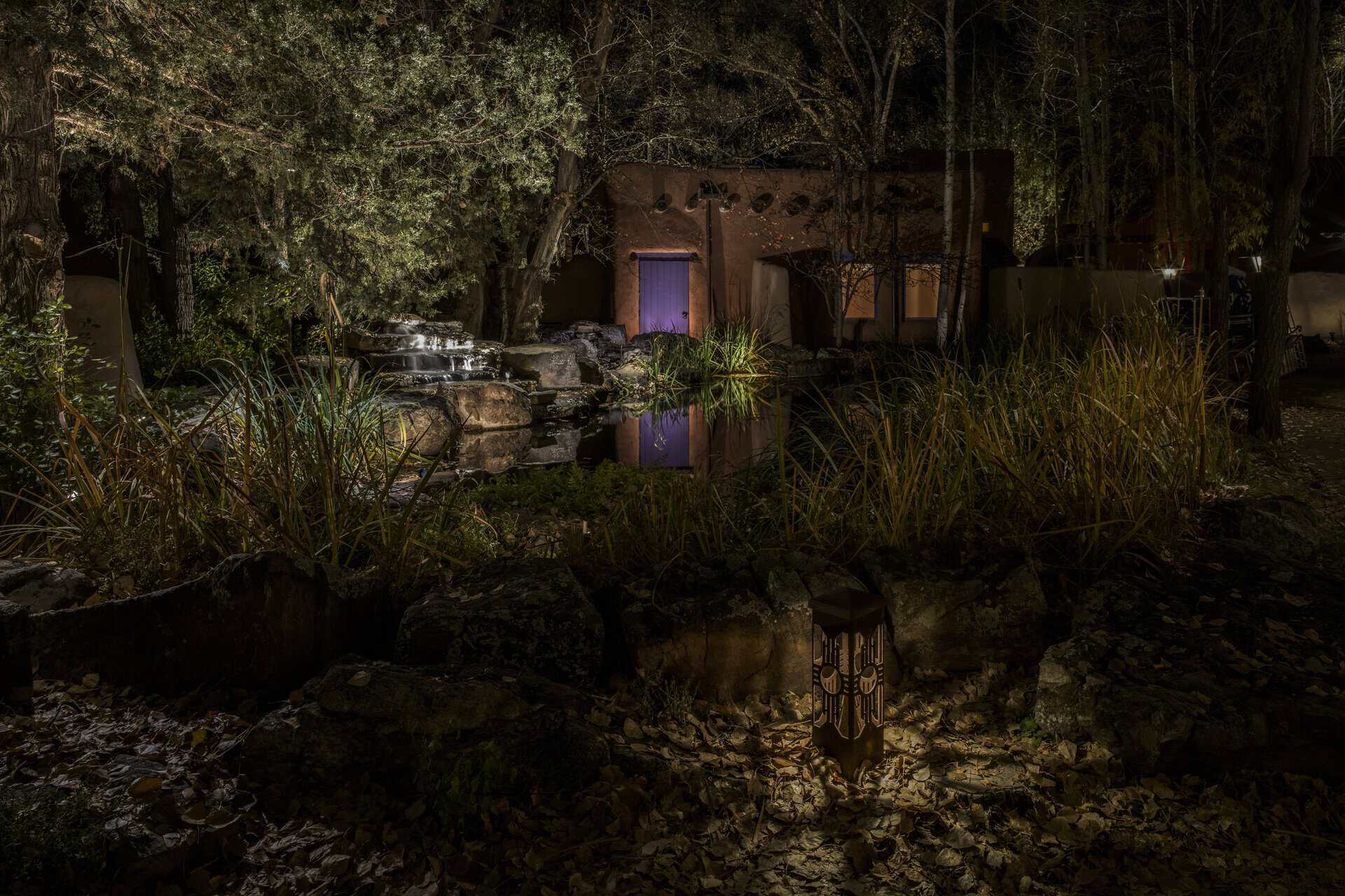 Long Island outdoor lighting around a garden pond and planting beds